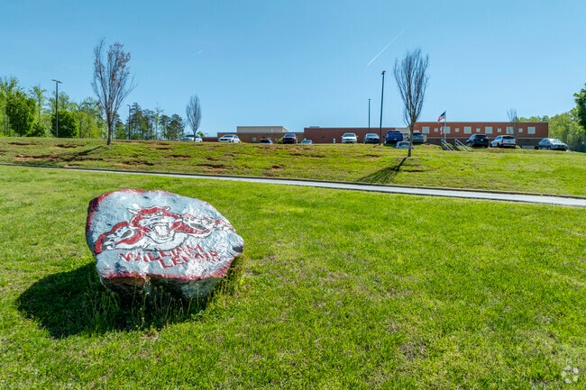 The school boulder is showcased near the entrance of the William Lenoir Middle School campus.