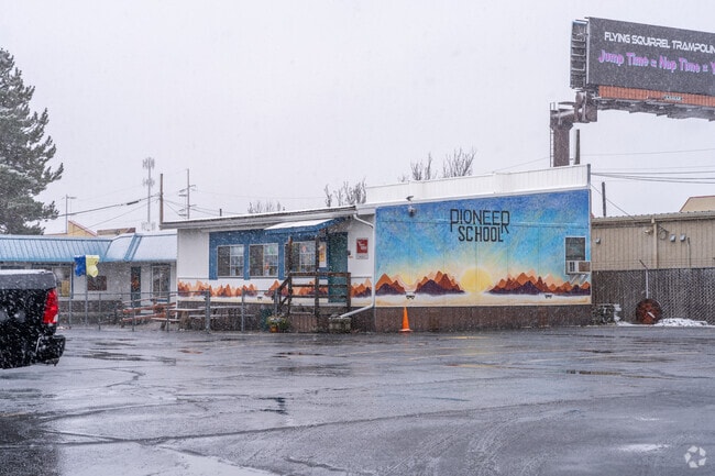 The Pioneer School is located near a commercial shopping center.