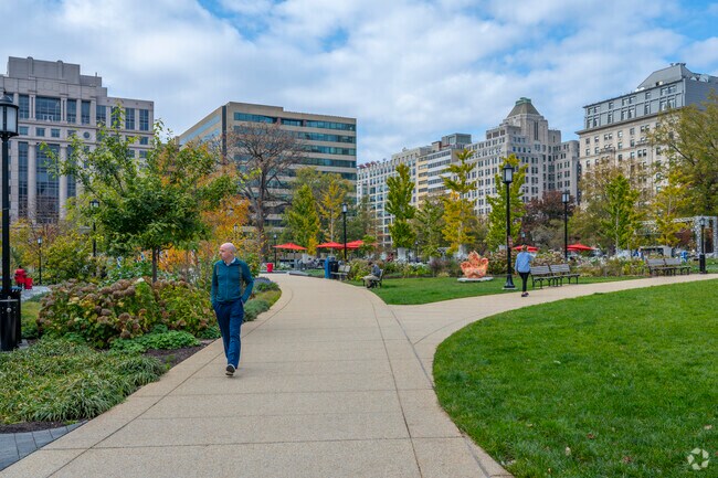 Franklin Park in Downtown DC has walking paths and a patio with chairs and tables.