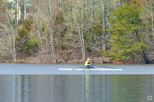 Deep River rowers glide across Oak Hollow Lake, enjoying calm water and scenic views.