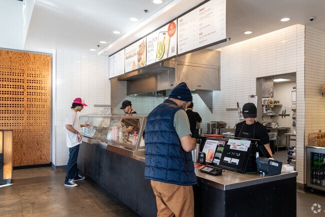A customer pays for his order at Chipotle in Clairemont Mesa East.