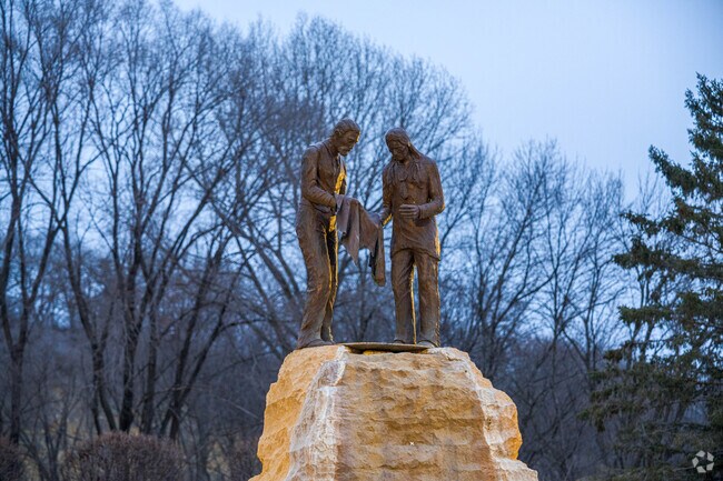 Faribault has a statue by the river referencing its textile industry.