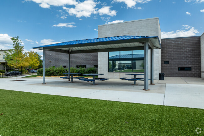 A pavilion provides shade for picnic tables at Early Light Academy.