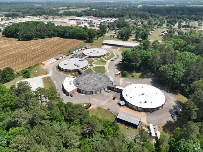 Limestone Co Area Voc Tech is surrounded by tress and greenery.