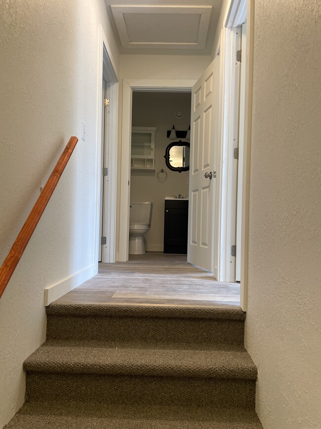 view of half bath coming up stairs