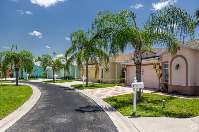 Homes in Corkscrew Woodlands are styled in vibrant colors, each with tropical landscaping.