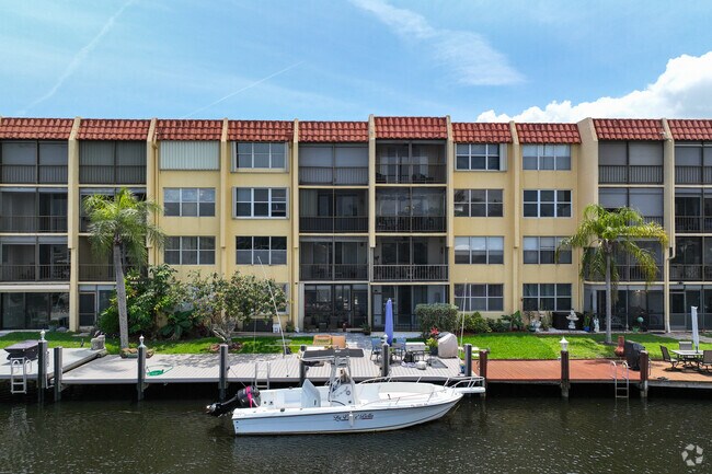 Four-story condominium complex by the water in the Pompano Shores neighborhood.