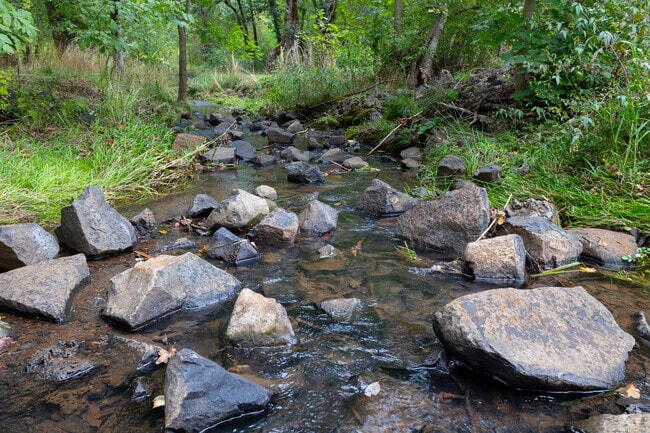 Water flows around rocks in a creek in South Gate.