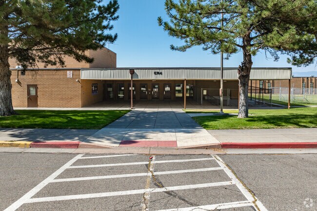 Large trees frame the entrance at Douglas T. Orchard Elementary School.