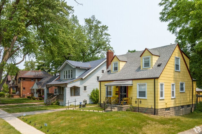A colorful Cape Cod-style cottage sits next to a Craftsman home in Five Points.