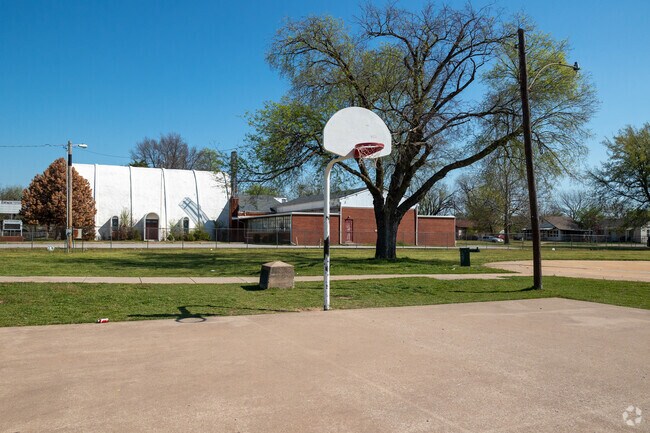 Penny Park includes a half basketball court and shaded seating.