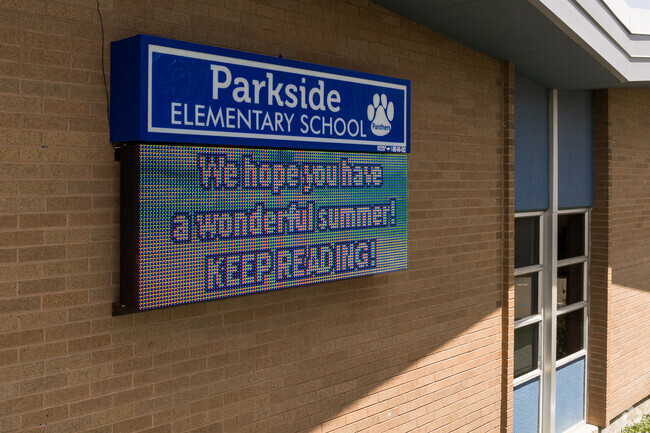 An electronic sign is attached to the brick wall of Parkside Elementary School.
