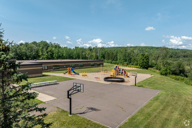 Lakewood Elementary School has a large recess area including a playground and basketball court.