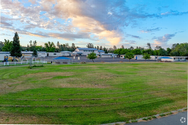 Beautiful sunset over grassy fields of Bukeye School Of The Arts.