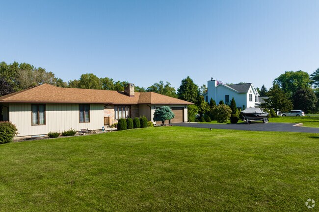 This row of homes features a ranch style home with a traditional one in the background.