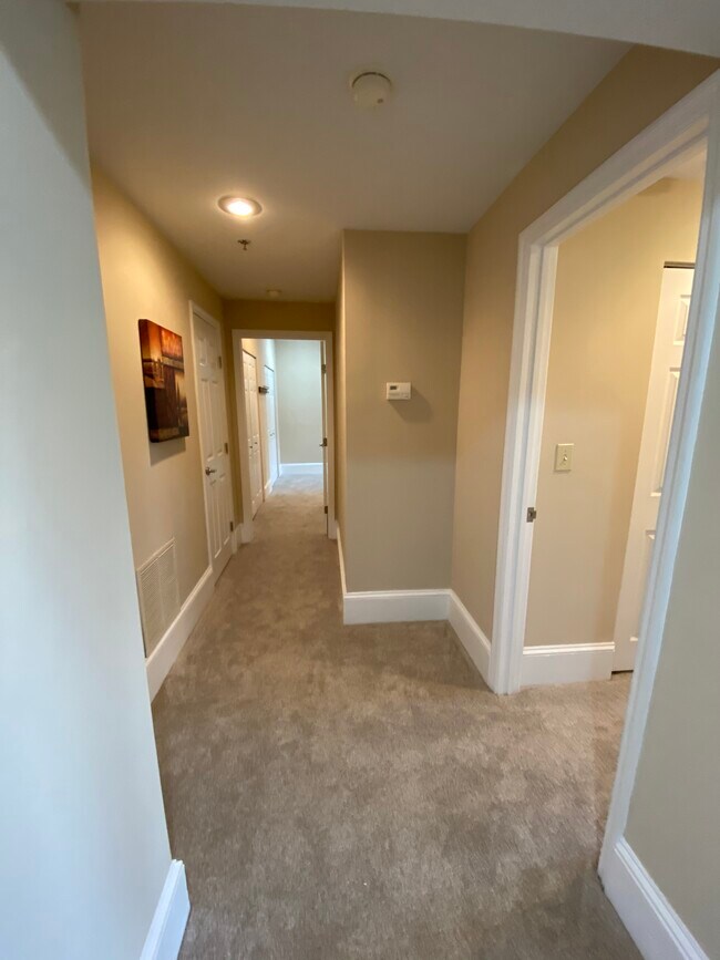 Hallway to bedrooms. Excellent storage.