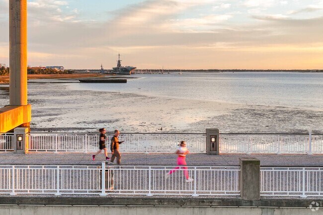 Longpoint residents run along a pier beneath the Ravenel Bridge in Mount Pleasant.
