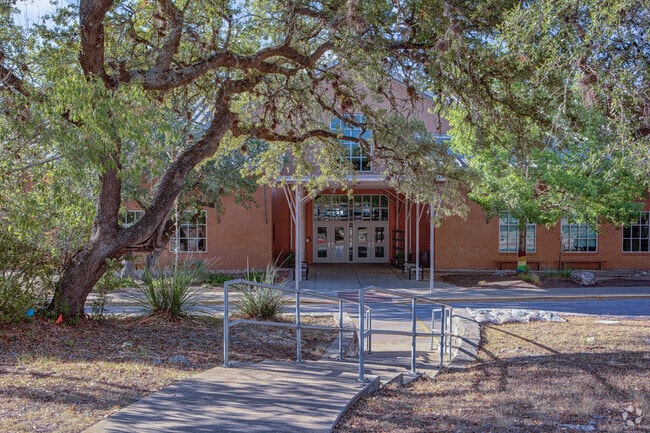 Trees shade the walkway to Clayton Elementary in Circle C Ranch.