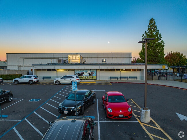 Students sit at tables behind gate at Will Rogers Middle School.