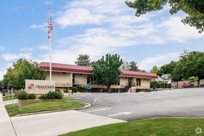 American flag hangs in an elegant spiral in front of Challenger School on a beautiful summer day