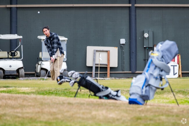 Knik-Fairview golfers practice their swing at Settlers Bay Golf Course.