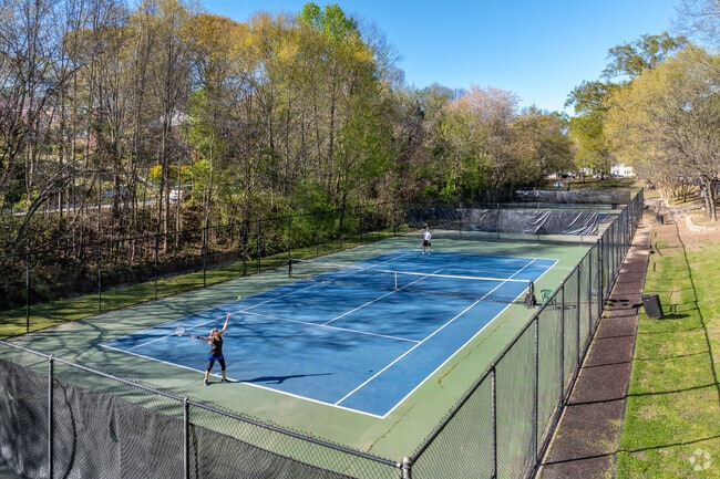 Local residents enjoy a game of tennis at Goldsboro Park in the Candler Park neighborhood.