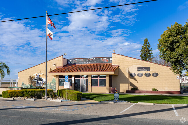 An American flag waves outside the entrance to Lovell High School in Cutler.