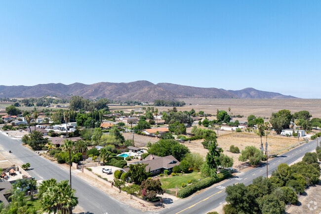 Aerial view of Sage’s rolling hills and scattered ranches highlighting rural living.