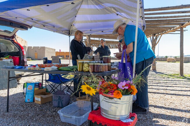 A couple browses the items at the Pojoaque Farmers Market.