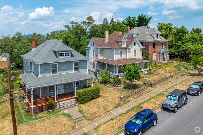 A row with an American Four Square, Folk Victorian and dilapidated house.