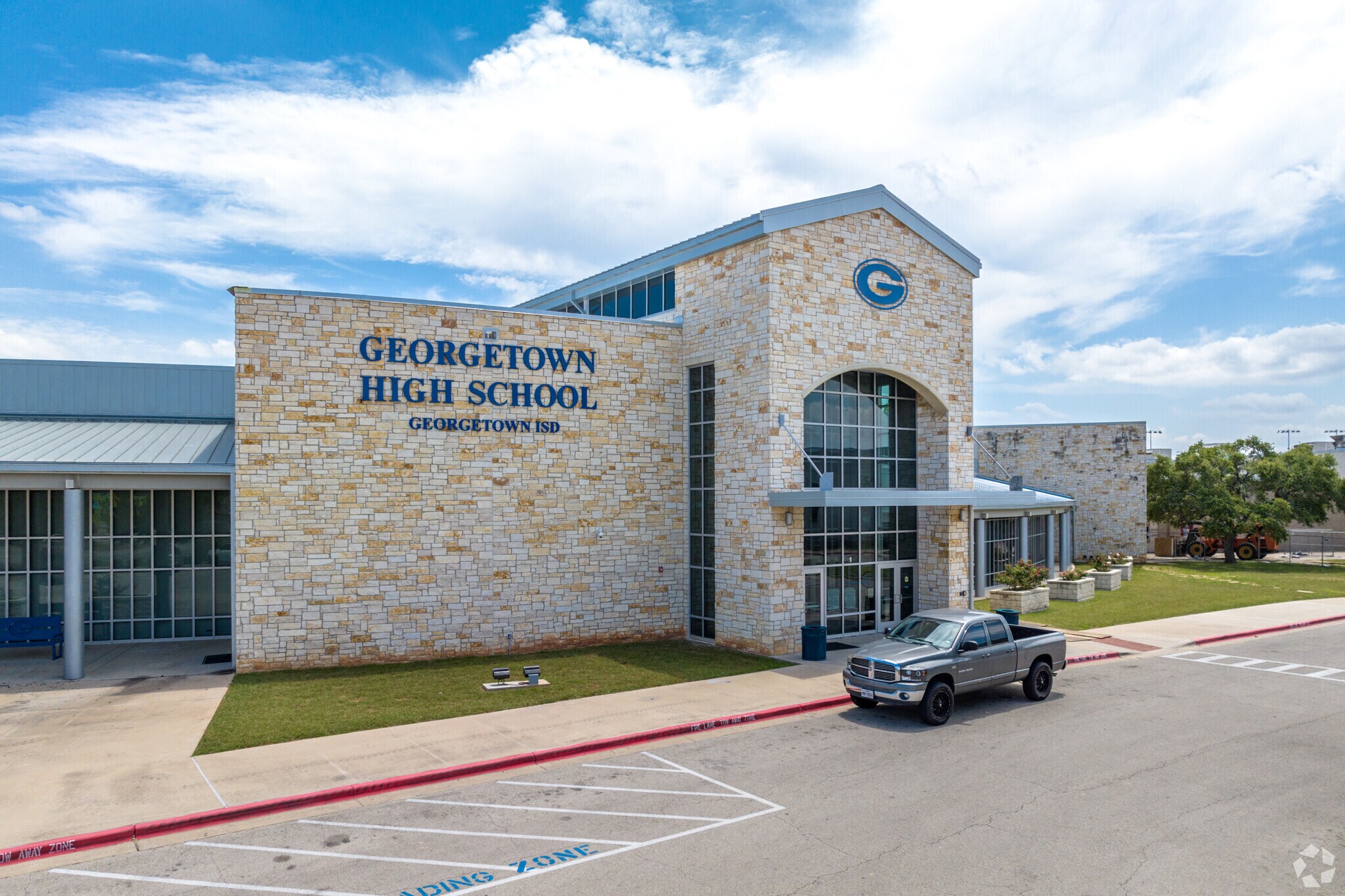 A grand stone and glass entrance welcomes students to Georgetown High School in Georgetown, TX.