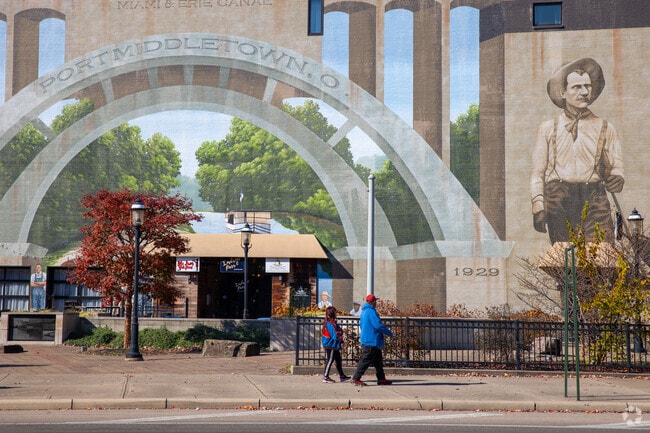 Residents admire the historic wall design depicting the Miami Erie Canal near the church.