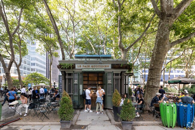People utilize Bryant Park for outdoor lunches.