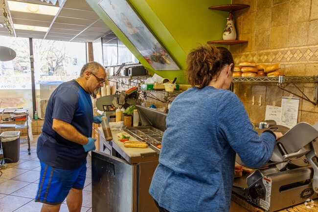 At Giovanni's Delicatessen, its owners make preparations and provide customer service.