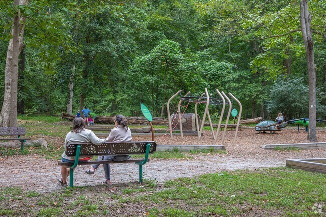 Parents watch over their kids as they play in one of the park's many amenities.
