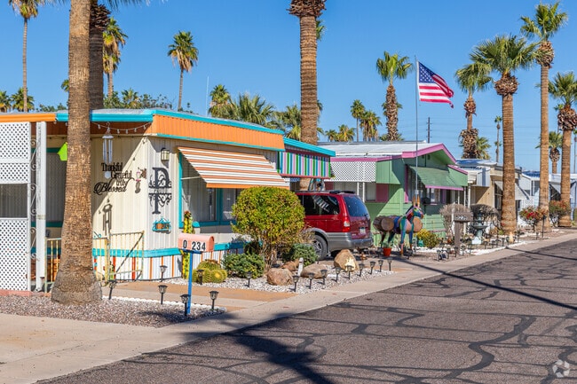 Colorful mobile homes sit below tall palms in North Mountain Village.