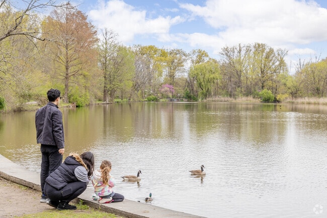 A family contemplates Willowbrook Lake.