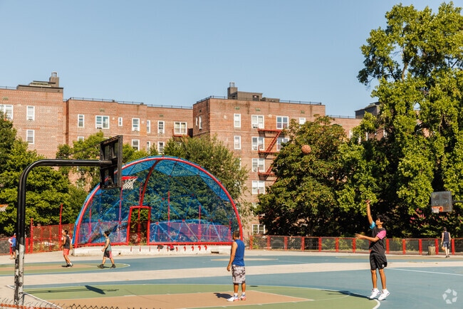 Residents play basketball in the park