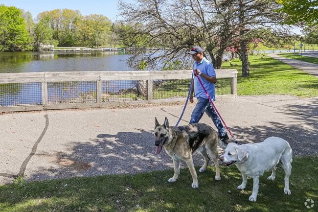 Dog walking is a popular activity along the Grand River in Averill Woods, Lansing.