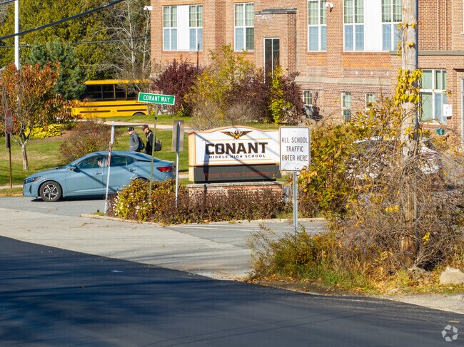 Students walk past the entrance of Conant Middle High School near Rindge.