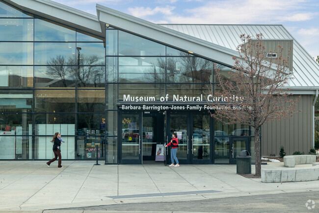 Women and a baby get ready to enter the Museum of Natural Curiosity in Thanksgiving.