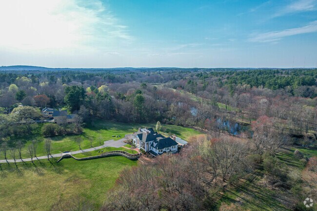 A large estate home with a private driveway and river access in the Dover community.