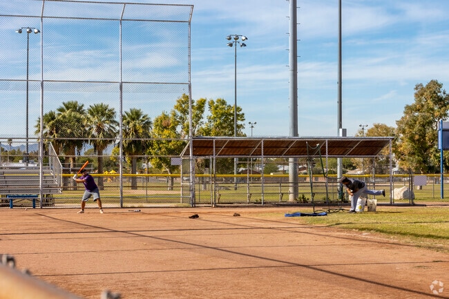 Tucson residents practice baseball in the afternoon at Palo Verde Park.