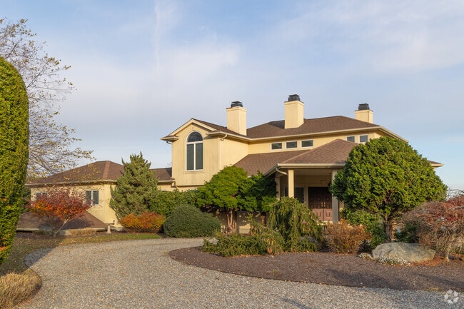 A Spanish style home in the Bristol Highlands neighborhood has nature with mature plantings.