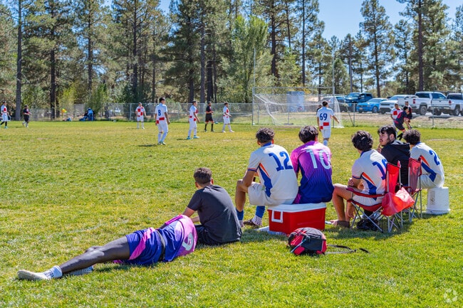 The soccer team is waiting on the sidelines to play at Thorpe Park Sport Complex in North End.