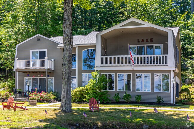 Homes in Gilford include large lake houses with green space surrounding them.