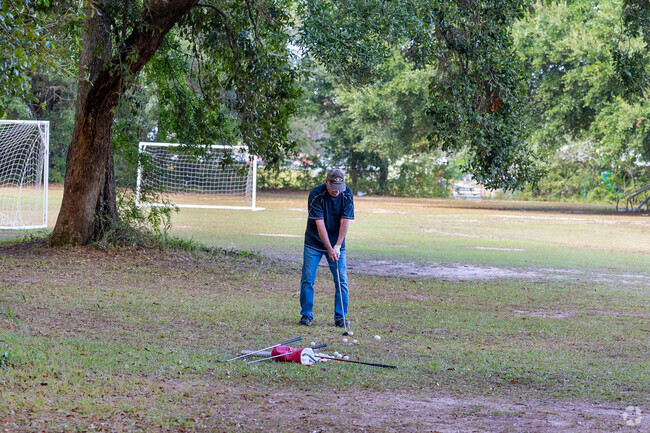 Residents often use the large green space at West Mobile County Park to hit golf balls.