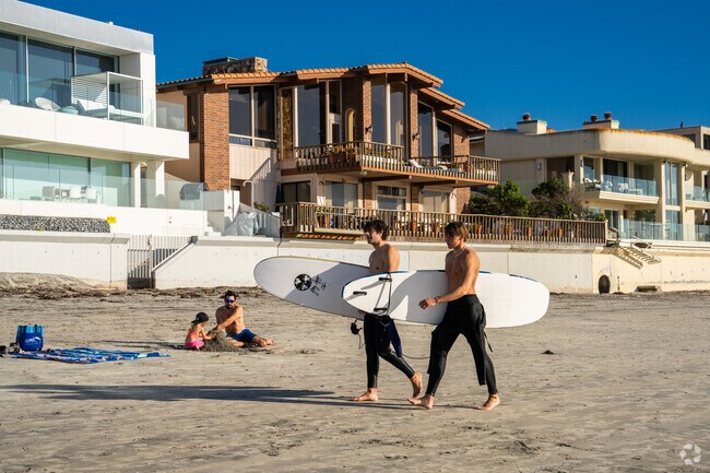 Houses sit right on the sand in Beach Barber Tract and locals can hop on a wave anytime.