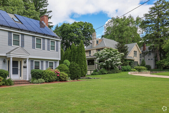 Rows of Colonial homes with green lawns line the street of Prospect Hill
