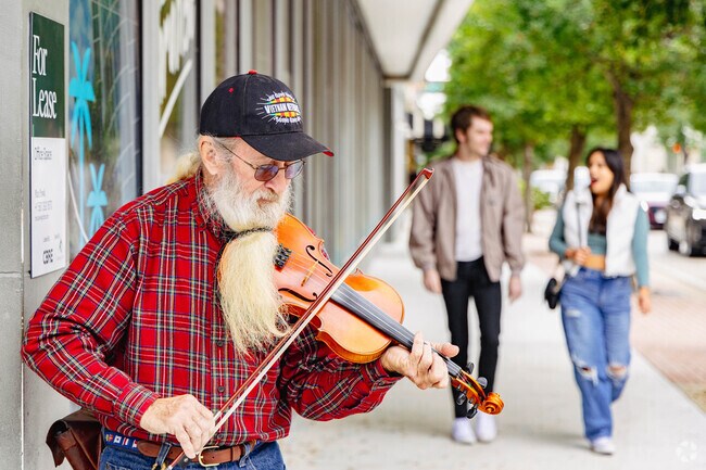 A violinist entertains pedestrians on Clematis street in West Palm Beach..